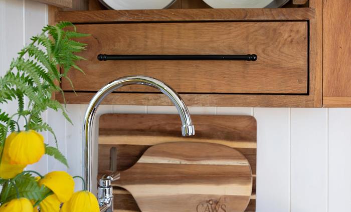 Induction hob and oven, cutlery, crockery, utensils, pots and pans. Small built-in fridge with freezer drawer for ice, SMEG Kettle, Coffee Plunger and